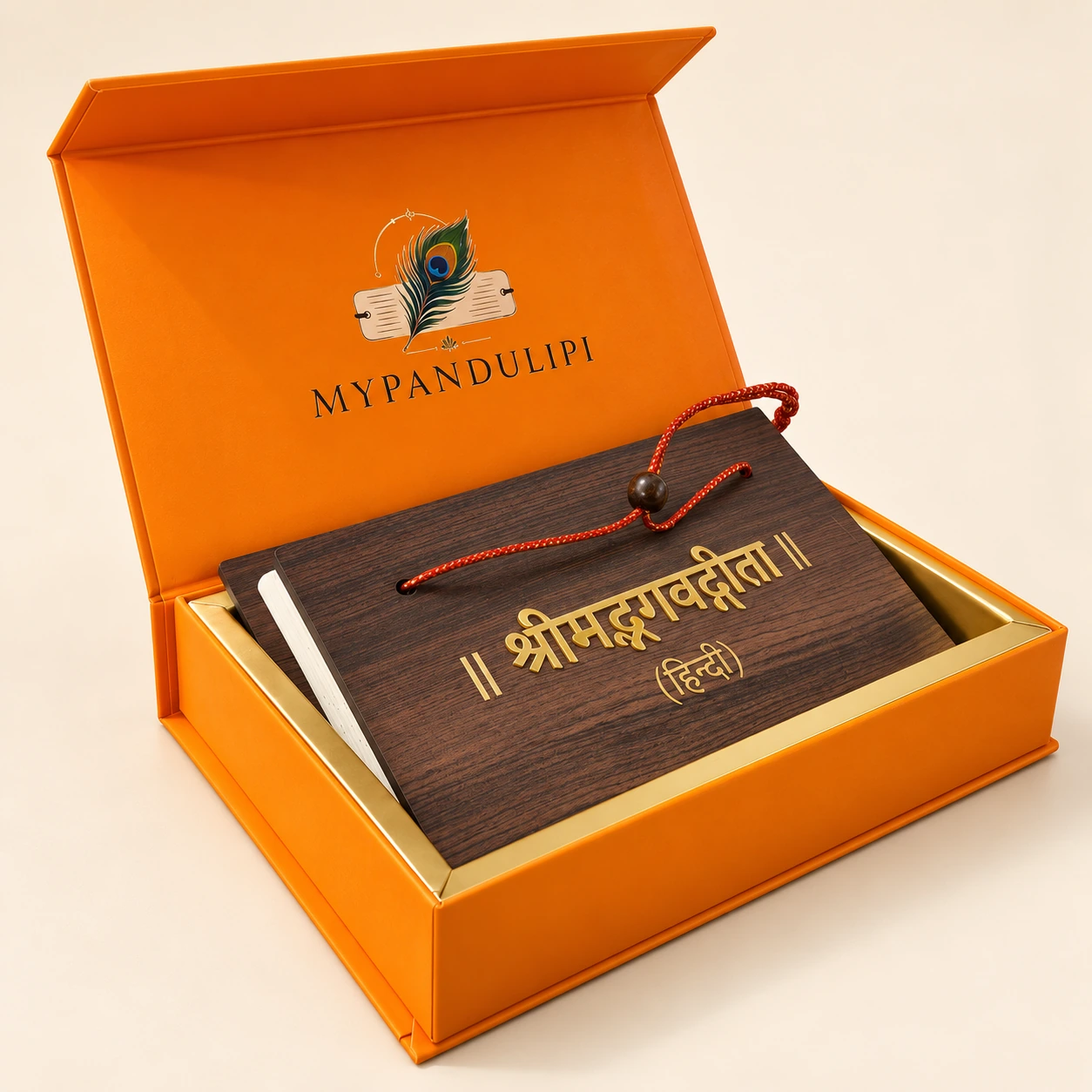 Angled view of the closed Bhagavad Gita wooden pandulipi and red thread tie in its orange premium gift box