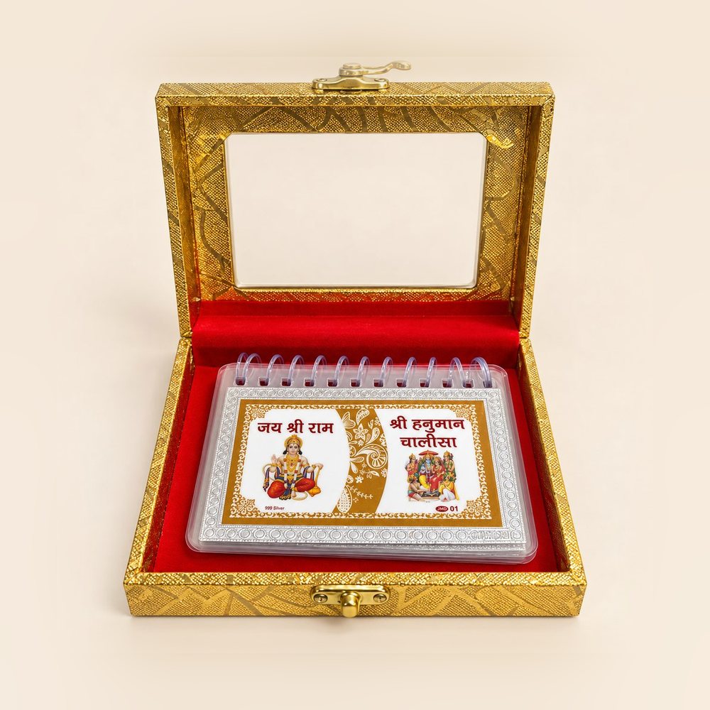 Silver Hanuman Chalisa resting on red velvet inside the open golden box
