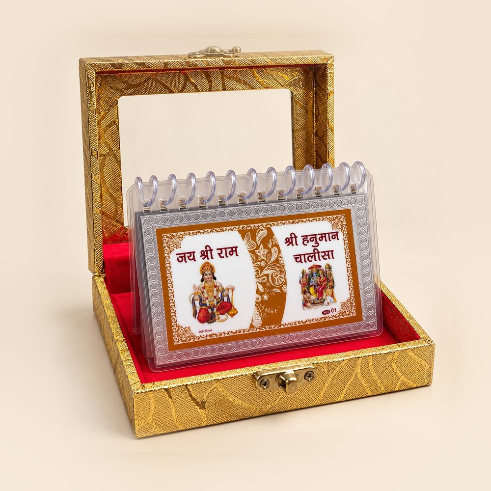 Silver Hanuman Chalisa flip book standing open in a golden gift box